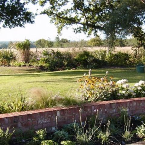 We planned and landscaped this 500sq/m property including the planting and nurturing of 5 seperate shrub gardens designed to complement the house and provide a yard of leisure within a farm plot.